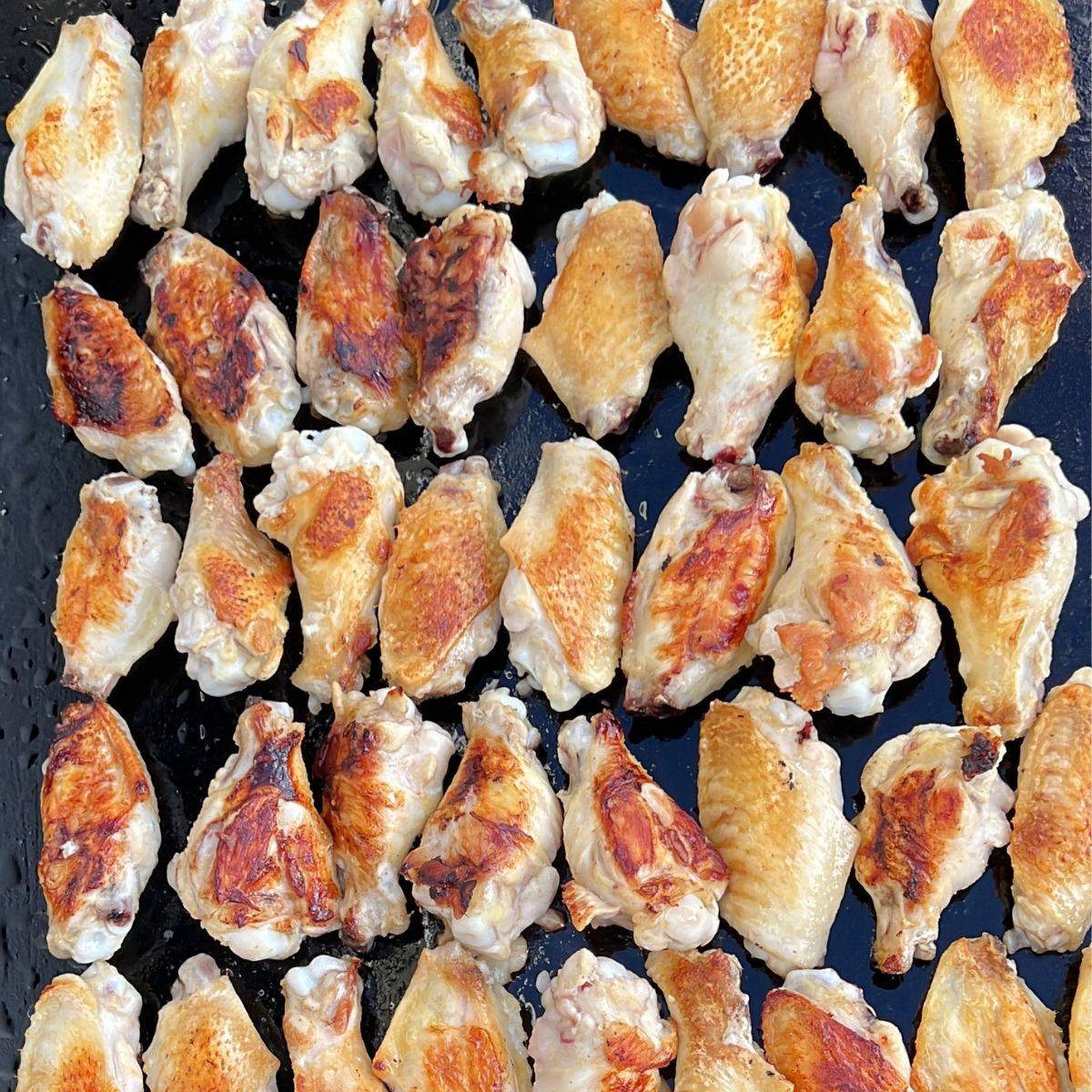 https://bestblackstonerecipes.com/wp-content/uploads/2022/12/Mastering-How-to-Cook-Wings-on-Blackstone-Griddle-7.jpg