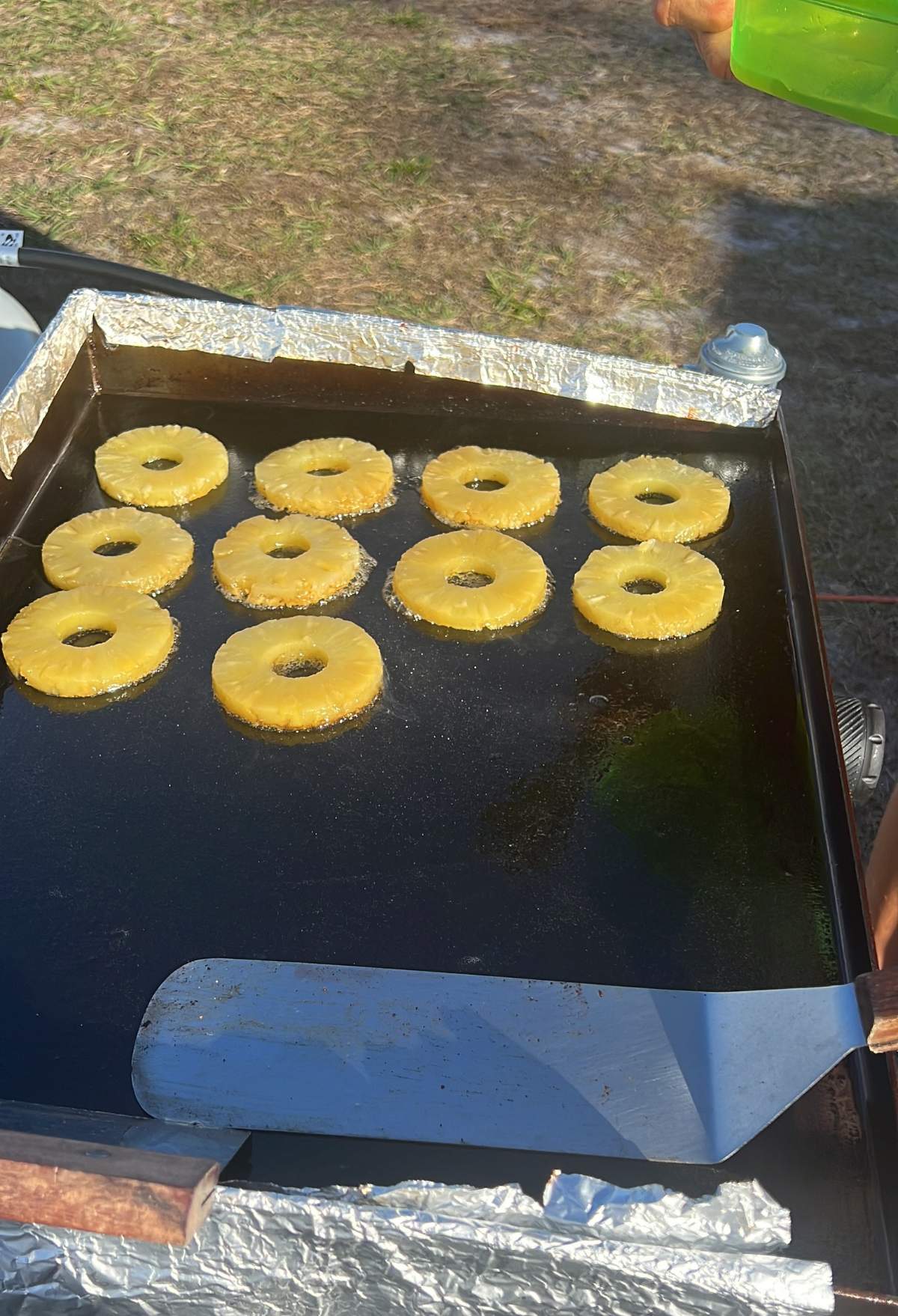 sliced pineapples on a blackstone griddle