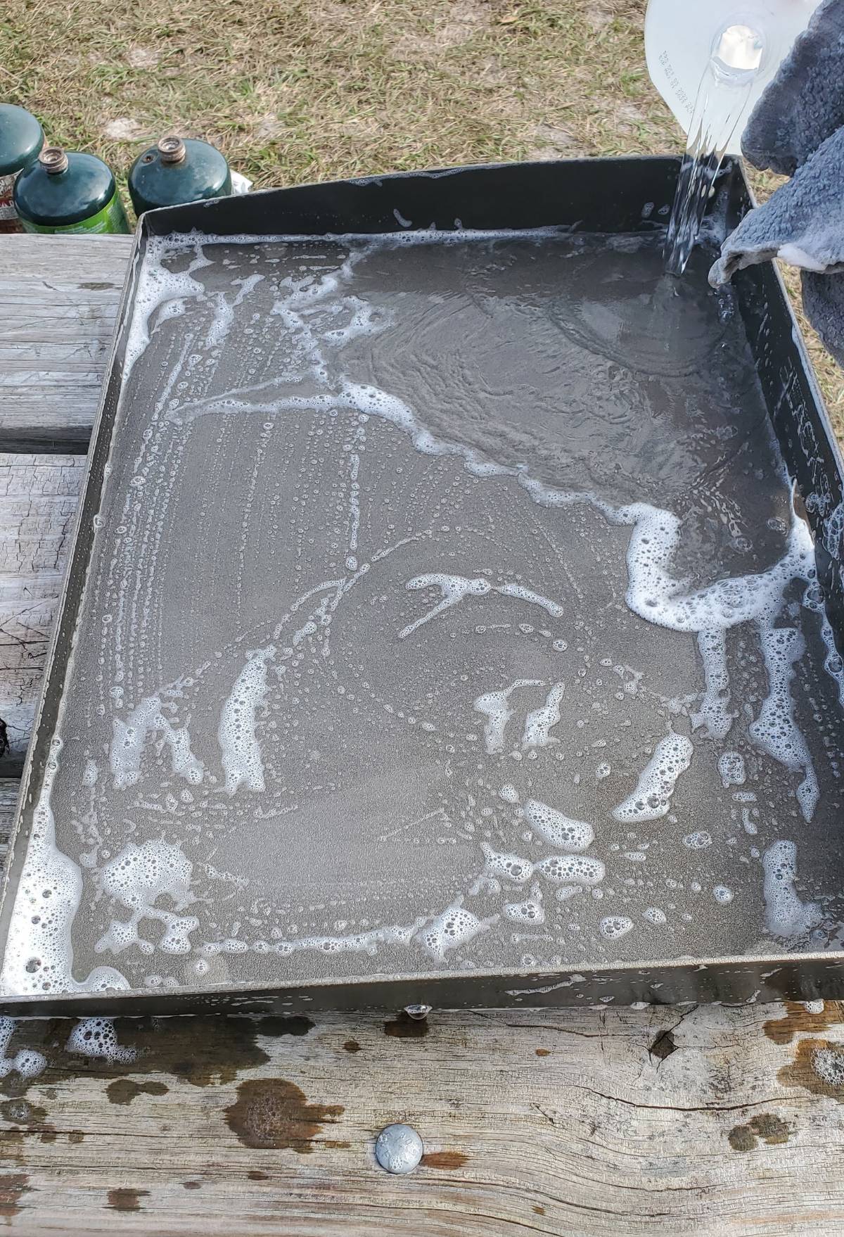 washing a blackstone griddle with soapy water