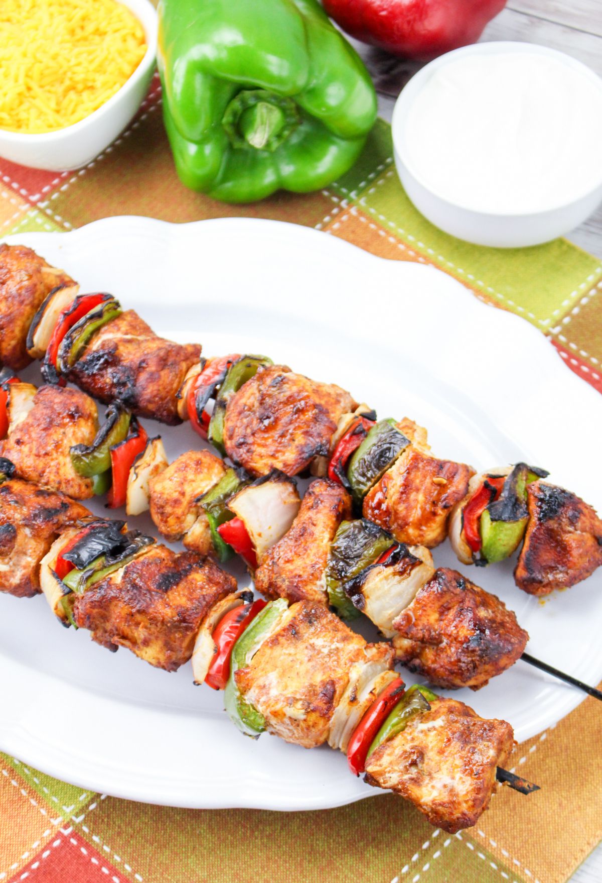 Grilled chicken skewers on a plate.