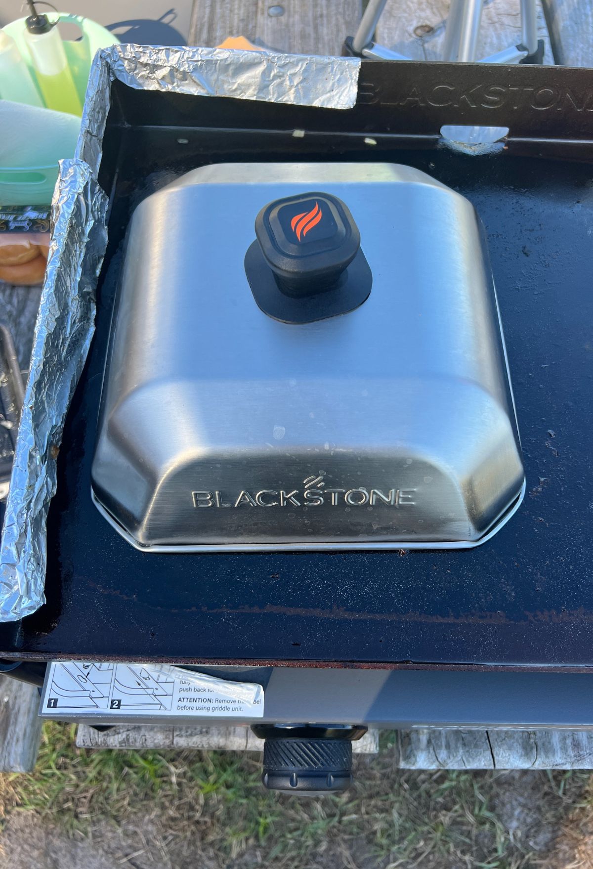 A blackstone grill with a lid on it.