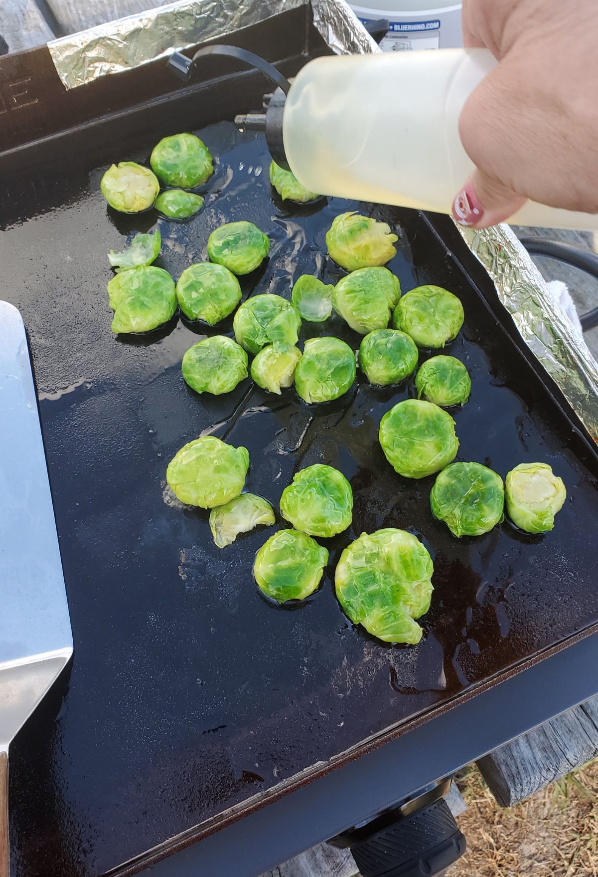 Brussel sprouts being cooked on a grill.