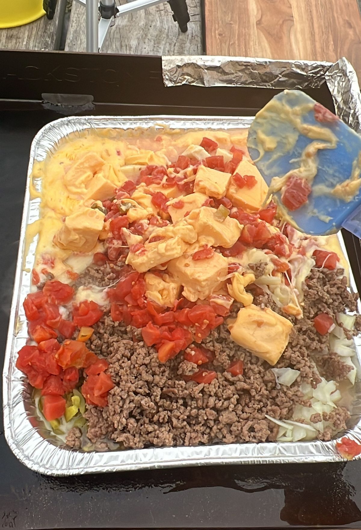 A tray full of food on a table with a spatula.