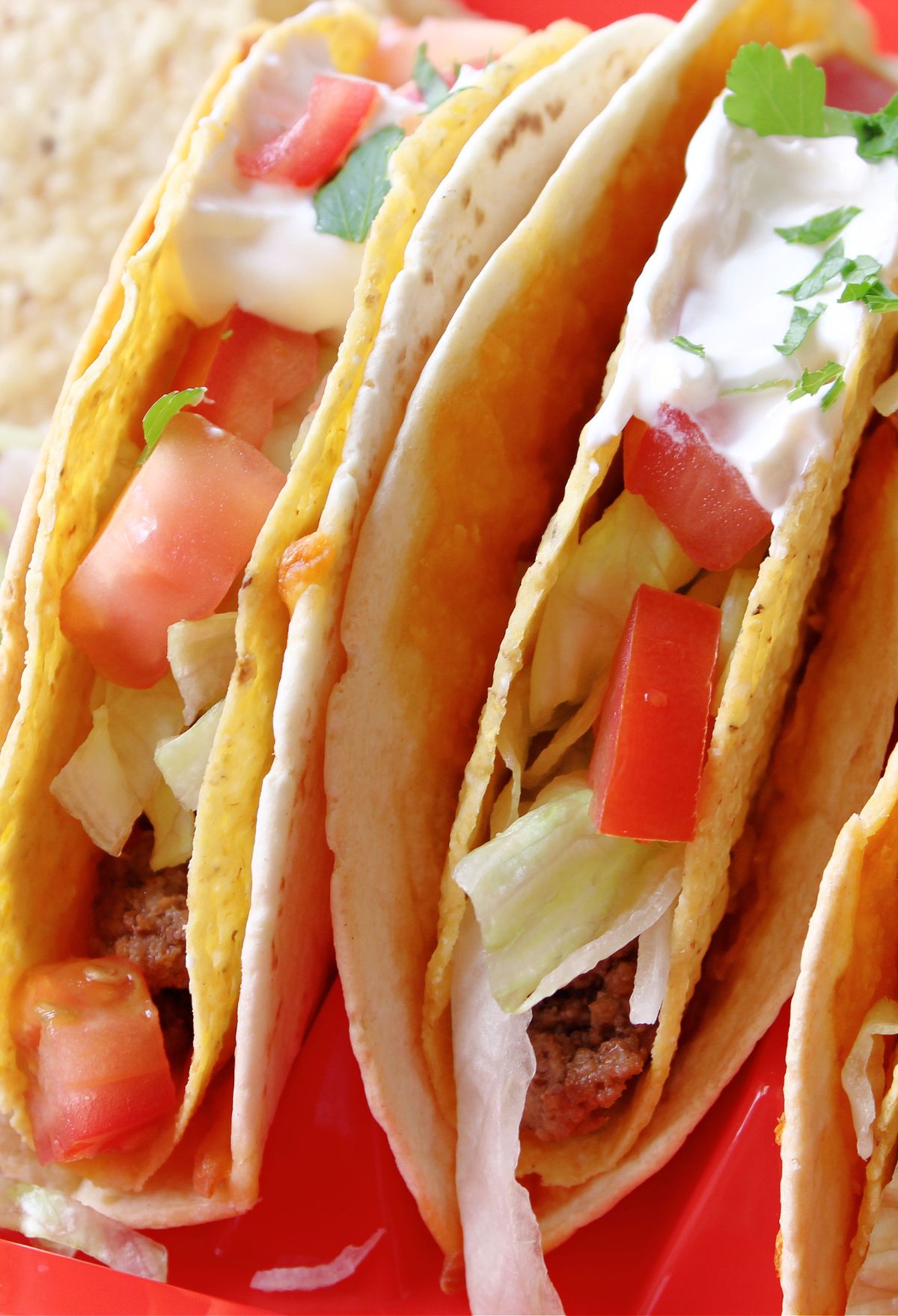 Three tacos on a red plate. Blackstone Taco Bell Cheesy Gordita Crunch Copycat