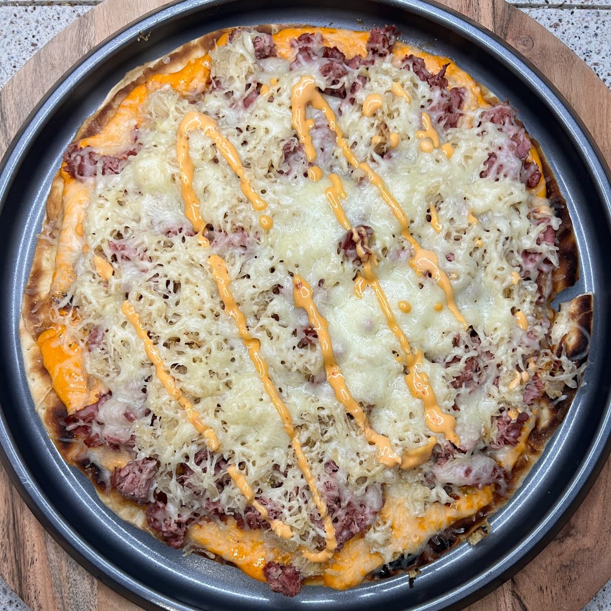 A pizza with meat and cheese on top.