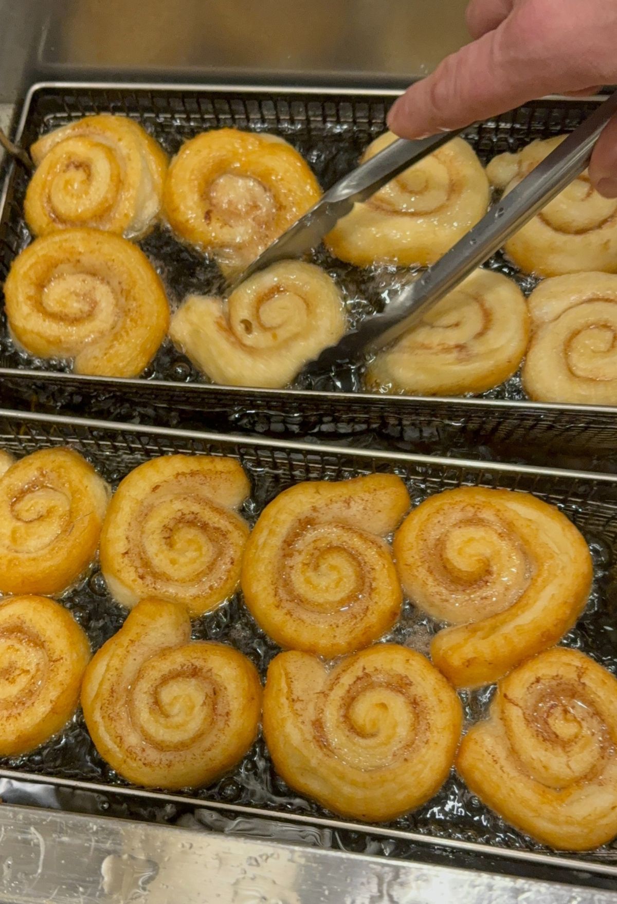Frying spiral-shaped dough in hot oil.