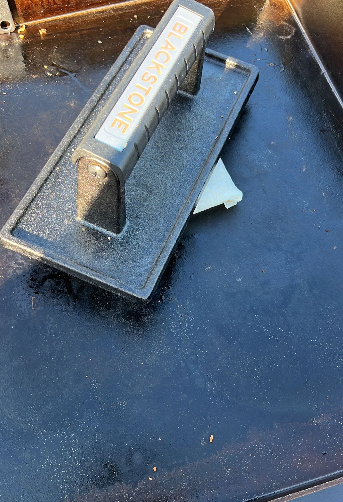 A discarded cigarette butt on a metal ashtray with the word "no smoking" visible.